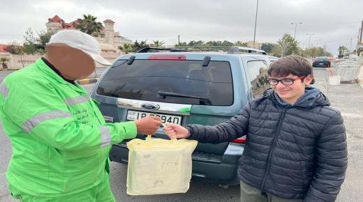 بالصور .. طفل يوزع هدايا على عمال الوطن في عمان